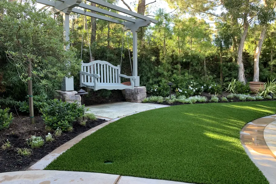 Lawn under a white pergola swing