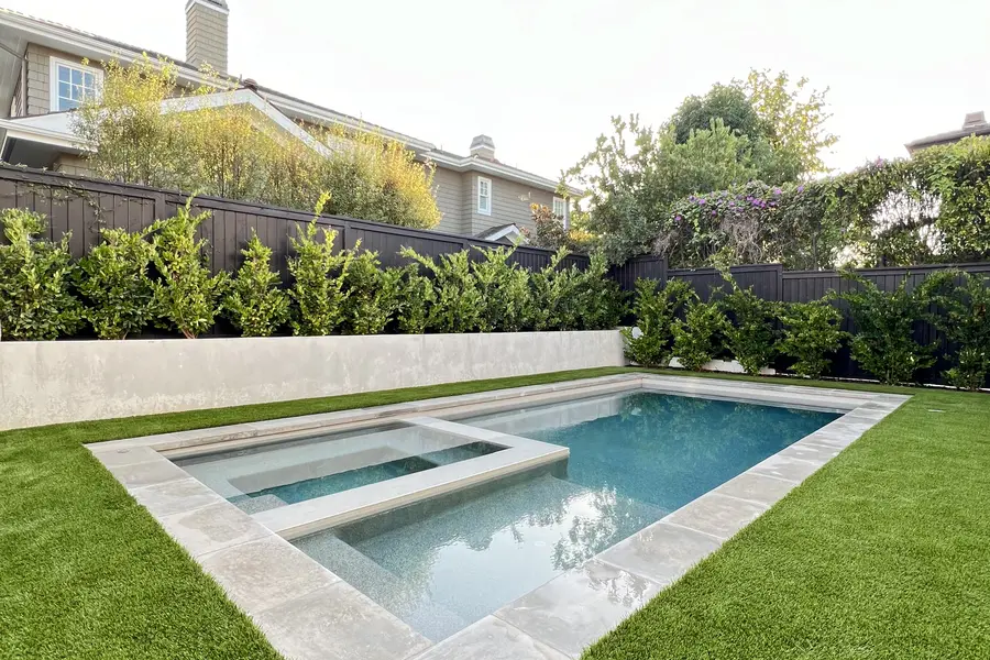 Modern pool and spa edged in artificial turf