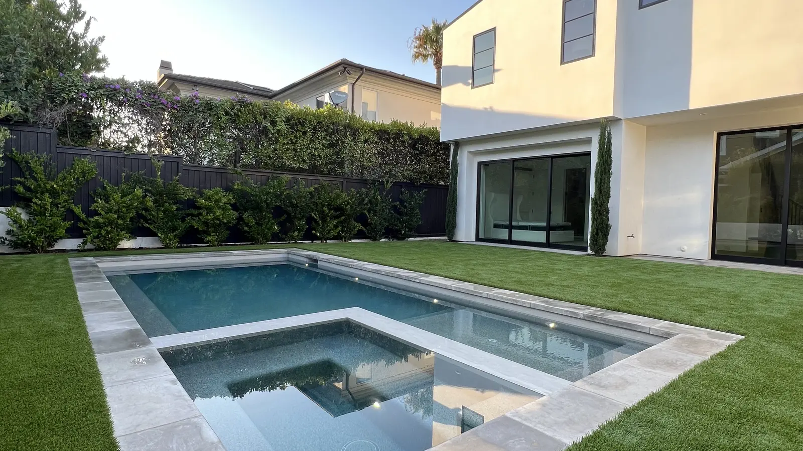 Modern Orange County backyard with artificial turf lawn around a pool