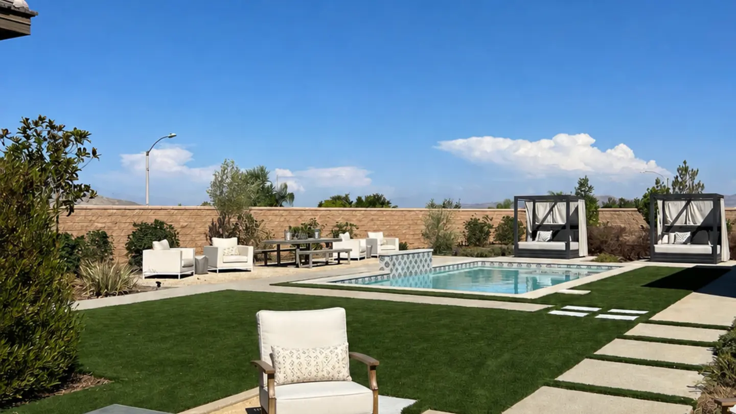 Finished backyard with artificial turf, pool, and lounge seating