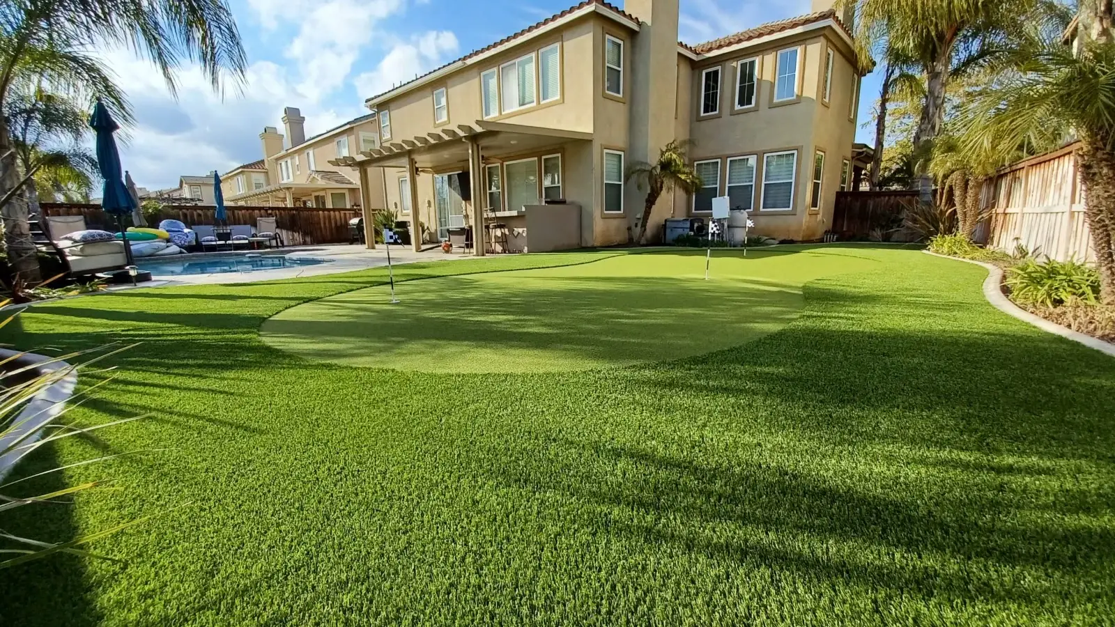 Large artificial lawn in front of a two-story Orange County home